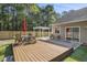 Spacious backyard featuring a wooden deck and white pergola at 214 Deer Ridge Court Ct, Huger, SC 29450