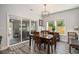 Bright dining room with wood table, sliding door, and modern light fixture at 214 Deer Ridge Court Ct, Huger, SC 29450