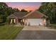 Charming brick home featuring a two-car garage, well-manicured landscaping, and inviting curb appeal at 214 Deer Ridge Court Ct, Huger, SC 29450
