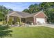 Well-maintained brick home with a two-car garage and an attractive landscaped front yard at 214 Deer Ridge Court Ct, Huger, SC 29450