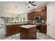 Well-lit kitchen with stainless appliances, a granite island, and backyard access at 214 Deer Ridge Court Ct, Huger, SC 29450