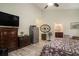 Main bedroom featuring a ceiling fan, dresser, and view into the bathroom at 214 Deer Ridge Court Ct, Huger, SC 29450