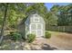 Backyard shed with white trim and double doors, providing ample outdoor storage space at 214 Deer Ridge Court Ct, Huger, SC 29450