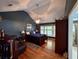 Elegant bedroom with dark blue walls, wood floors, ceiling fan, and a four-poster bed at 2206 Hunter Creek Dr, Charleston, SC 29414