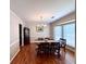 Elegant dining room with hardwood floors, a traditional chandelier, and a large window for natural light at 2206 Hunter Creek Dr, Charleston, SC 29414