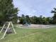 Community playground with a swing set, climbing structure, and a slide at 2206 Hunter Creek Dr, Charleston, SC 29414