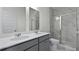 Bright bathroom featuring a double sink vanity and a glass-enclosed shower with marble-style tile surround at 222 Terrace View Dr, Summerville, SC 29486