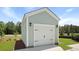 Exterior view of the garage features light siding, overhead lighting, and short driveway at 222 Terrace View Dr, Summerville, SC 29486