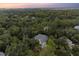 Aerial view showcases this homes location amidst mature trees with serene marsh views at 2340 Marsh Hen Dr, Seabrook Island, SC 29455