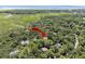 Aerial view showcases the homes location near tidal marshes and waterways, surrounded by lush greenery at 2340 Marsh Hen Dr, Seabrook Island, SC 29455