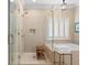 Bathroom boasting a glass shower, tub, and bright window with shutter at 2340 Marsh Hen Dr, Seabrook Island, SC 29455