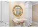 Elegant bathroom features a marble countertop, gold fixtures, and a large round mirror at 2340 Marsh Hen Dr, Seabrook Island, SC 29455
