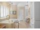Luxurious bathroom features a soaking tub, white cabinets, and bright lighting, creating a spa-like experience at 2340 Marsh Hen Dr, Seabrook Island, SC 29455