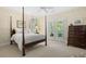 Bedroom featuring a four-poster bed and doors that lead to an outdoor view at 2340 Marsh Hen Dr, Seabrook Island, SC 29455