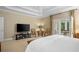 Cozy bedroom with TV, French doors to a private porch, plush carpets, and natural light throughout at 2340 Marsh Hen Dr, Seabrook Island, SC 29455