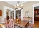 Cozy dining room with wood table, chandelier, light-colored walls and decorative trim at 2340 Marsh Hen Dr, Seabrook Island, SC 29455