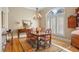 Elegant dining room with wood table, area rug, chandelier, and large window with plantation shutters at 2340 Marsh Hen Dr, Seabrook Island, SC 29455