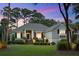 Well-manicured front yard with mature landscaping and an inviting entrance at twilight at 2340 Marsh Hen Dr, Seabrook Island, SC 29455
