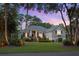 Well-manicured front yard with mature landscaping and an inviting entrance at twilight at 2340 Marsh Hen Dr, Seabrook Island, SC 29455
