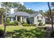 Beautifully landscaped front yard with mature trees and well-maintained lawn at 2340 Marsh Hen Dr, Seabrook Island, SC 29455