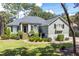 Beautifully landscaped front yard with mature trees and well-maintained lawn at 2340 Marsh Hen Dr, Seabrook Island, SC 29455