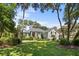 Welcoming home with a pristine lawn, mature trees, and classic architectural details at 2340 Marsh Hen Dr, Seabrook Island, SC 29455