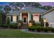 Charming single-story home featuring a columned front porch and meticulously landscaped front yard at 2340 Marsh Hen Dr, Seabrook Island, SC 29455