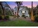 Well-manicured front yard with mature landscaping and an inviting entrance at twilight at 2340 Marsh Hen Dr, Seabrook Island, SC 29455