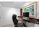 Home office with built in desk, executive chair and colorful painting at 2340 Marsh Hen Dr, Seabrook Island, SC 29455