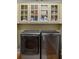 Close-up of front loading washer and dryer with storage above at 2340 Marsh Hen Dr, Seabrook Island, SC 29455