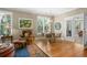 Elegant living room featuring hardwood floors, plantation shutters, a leather chair and access to the outdoors at 2340 Marsh Hen Dr, Seabrook Island, SC 29455