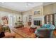 Open living room with fireplace, hardwood floors, neutral colors, and comfortable furnishings at 2340 Marsh Hen Dr, Seabrook Island, SC 29455