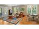 Elegant living room featuring hardwood floors, plantation shutters, a leather chair and access to the outdoors at 2340 Marsh Hen Dr, Seabrook Island, SC 29455