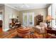 Comfortable seating area with hardwood floors, built-ins, natural light, and French doors leading to outdoor living at 2340 Marsh Hen Dr, Seabrook Island, SC 29455