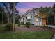 Well-maintained home featuring a side entry garage and lush landscaping with mature trees at 2340 Marsh Hen Dr, Seabrook Island, SC 29455