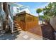 View of backyard, stairs, and deck with hot tub of two-story home at 2407 Cameron Blvd, Isle of Palms, SC 29451