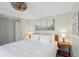 Bright bedroom features a ceiling fan, neutral walls, wood flooring, and a comfortable queen sized bed at 2407 Cameron Blvd, Isle of Palms, SC 29451