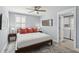 Bright bedroom features a stylish rug, ceiling fan, and an adjacent laundry area at 2407 Cameron Blvd, Isle of Palms, SC 29451