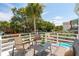 Cozy outdoor deck with comfortable seating and a partial view of a nearby pool at 2407 Cameron Blvd, Isle of Palms, SC 29451
