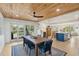 Dining room and kitchen combined area with wood ceiling, stylish seating, and open concept layout at 2407 Cameron Blvd, Isle of Palms, SC 29451