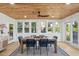 Cozy dining area featuring a wood ceiling, ample natural light, and stylish blue chairs at 2407 Cameron Blvd, Isle of Palms, SC 29451
