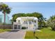 Inviting two-story home featuring a well-maintained yard and a classic white facade at 2407 Cameron Blvd, Isle of Palms, SC 29451