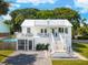 Charming two-story white home with a spacious deck and a screened-in porch at 2407 Cameron Blvd, Isle of Palms, SC 29451