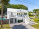 Elegant two-story home features a spacious screened porch, a patio, and lush landscaping at 2407 Cameron Blvd, Isle of Palms, SC 29451