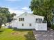 Stately two-story home boasts an attached garage, outdoor patio, and lush green lawn at 2407 Cameron Blvd, Isle of Palms, SC 29451