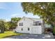 Charming white home with a garage, an outdoor seating area, and well-maintained landscaping at 2407 Cameron Blvd, Isle of Palms, SC 29451