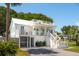 Elegant two-story white house with a deck, screened-in porch, and well-manicured lawn at 2407 Cameron Blvd, Isle of Palms, SC 29451