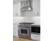 Close-up of a modern kitchen with stainless steel appliances, white subway tile backsplash, and custom cabinets at 2407 Cameron Blvd, Isle of Palms, SC 29451