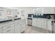Bright kitchen boasts white cabinets, stainless appliances, and unique backsplash at 2407 Cameron Blvd, Isle of Palms, SC 29451