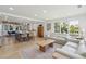 Bright open-concept living area with hardwood floors, modern sofas, and a view to the kitchen at 2407 Cameron Blvd, Isle of Palms, SC 29451